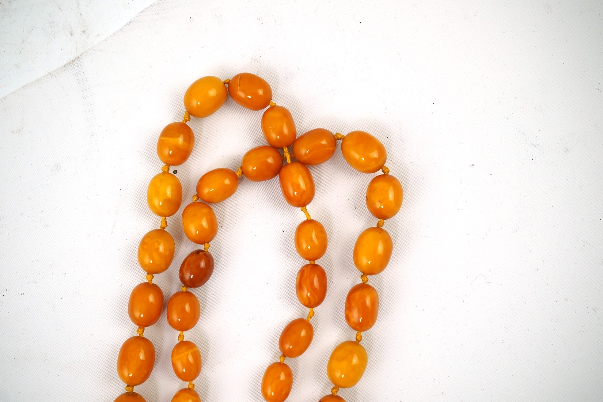 A single strand graduated oval amber bead necklace